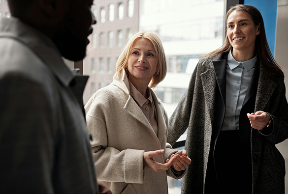  two women watching their partner talk